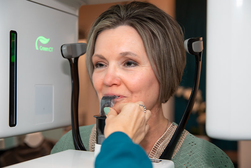 Team member taking a x-ray of patients mouth