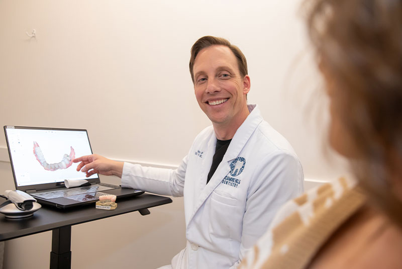 dentist going over 3d scan of patients teeth