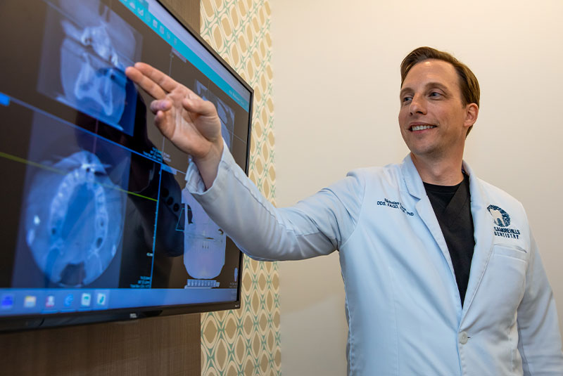 dentist going over x-rays of patients teeth