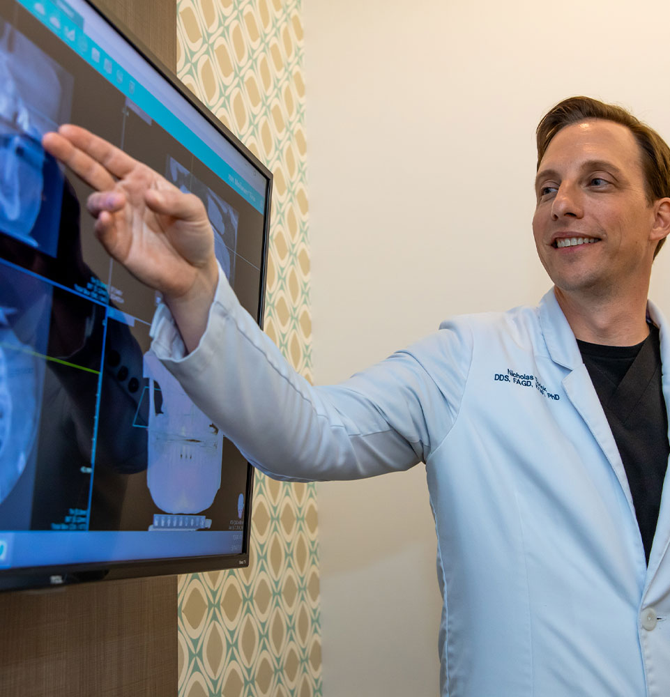 dentist going over x-ray with patient