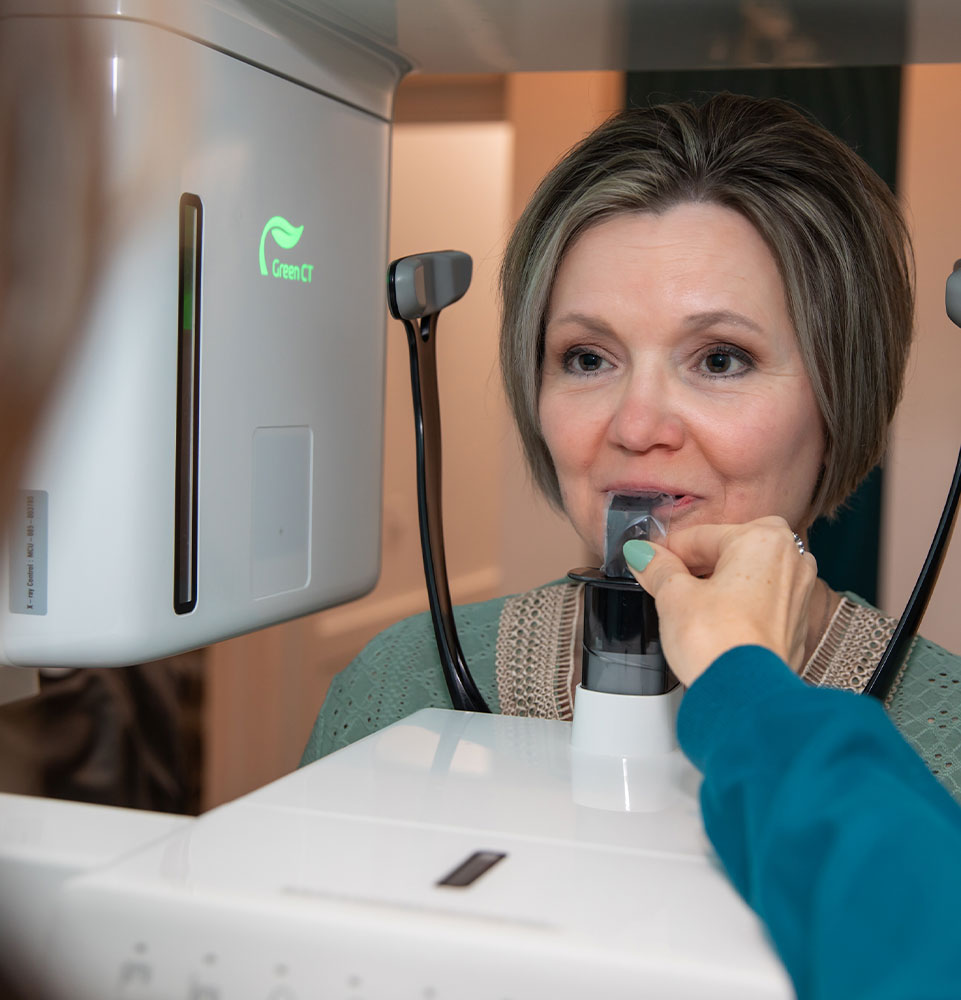 Patient in the middle of getting a x-ray of her teeth