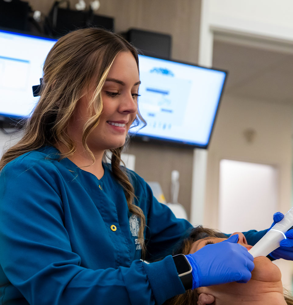 team member taking a 3d scan of patients mouth