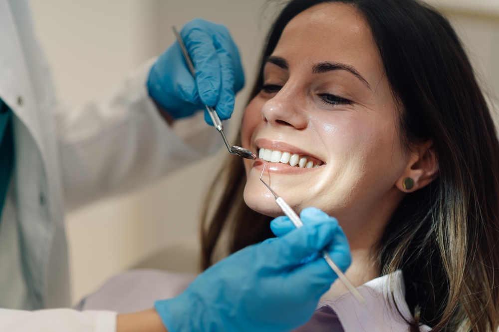 Dentist consulting patient on tooth sensitivity in a modern dental office